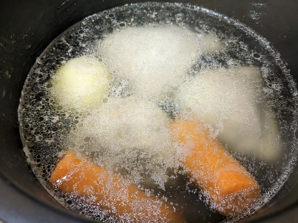 We skimmed off a small amount of foam using a slotted spoon, then moved the pan to the smallest burner, on low heat, and began to observe.