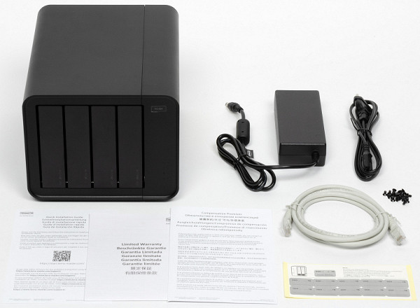 The kit includes the NAS itself in a plastic case, a power adapter with a detachable network cable, an Ethernet Cat5E patch cord, screws and stickers for marking the installed drives.